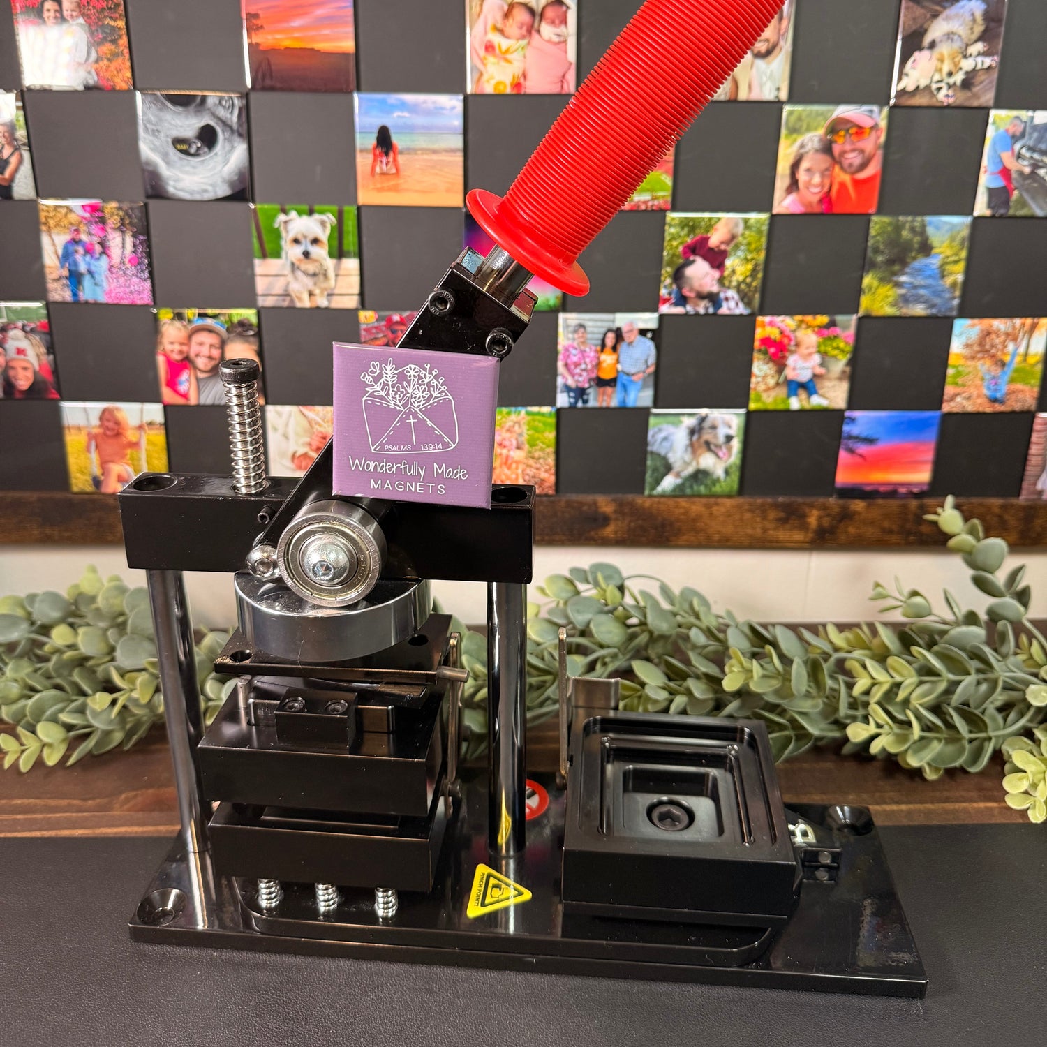 Magnet Making Machine with 2x2 custom photo magnets arranged on a magnetic board